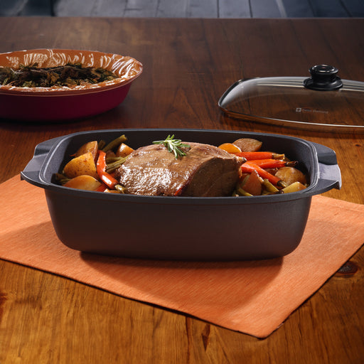 HD Nonstick 5.3 qt Roaster with Glass Lid in use on wooden dining room table