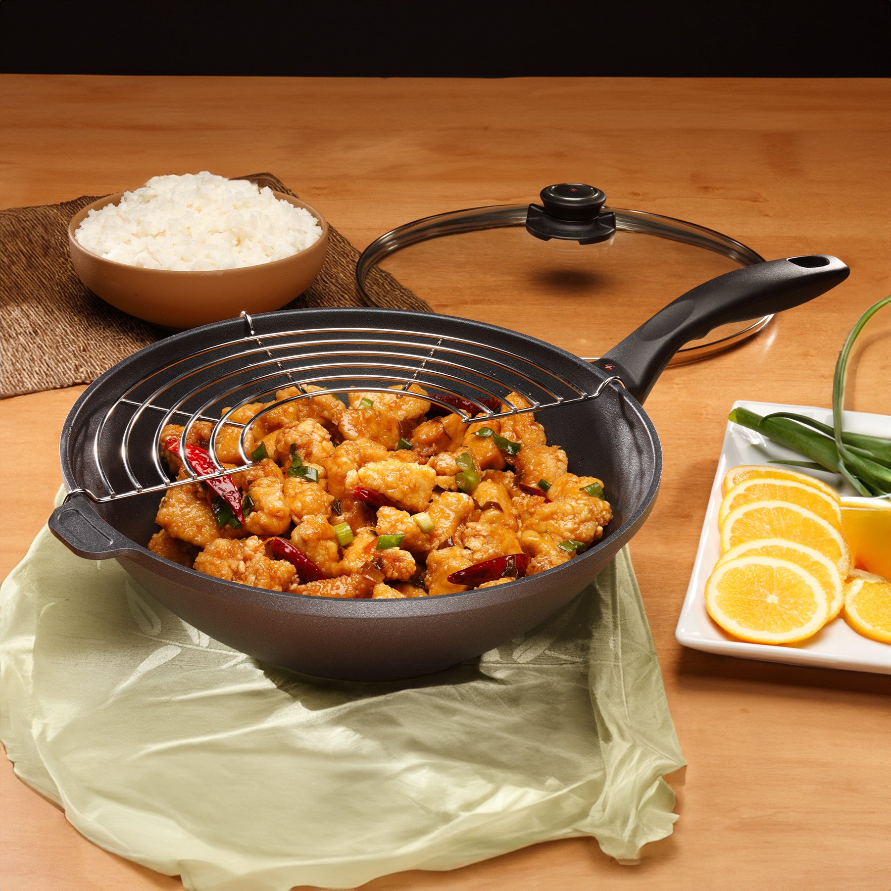 HD Nonstick Wok with Glass Lid & Rack in use on wooden dining room table