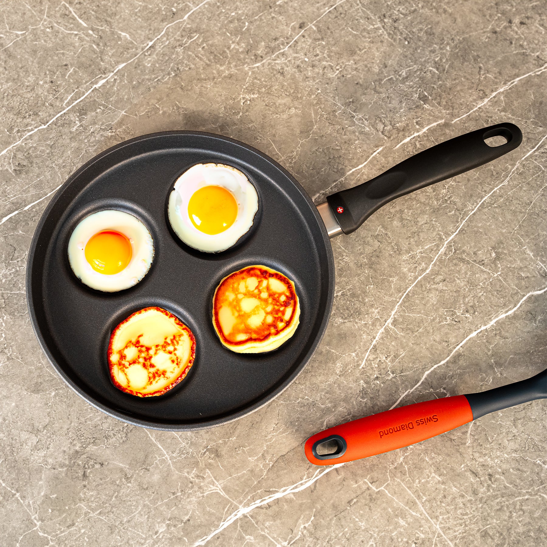 HD Nonstick 10.25" Plett Pan in use with eggs and pancakes on surface