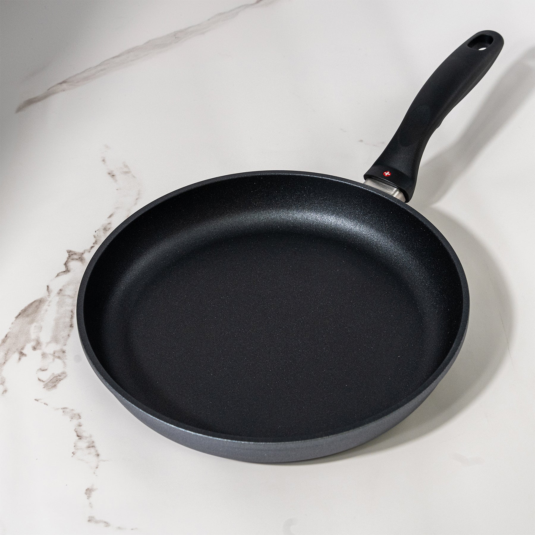 HD Nonstick Fry Pan in use on marble kitchen counter