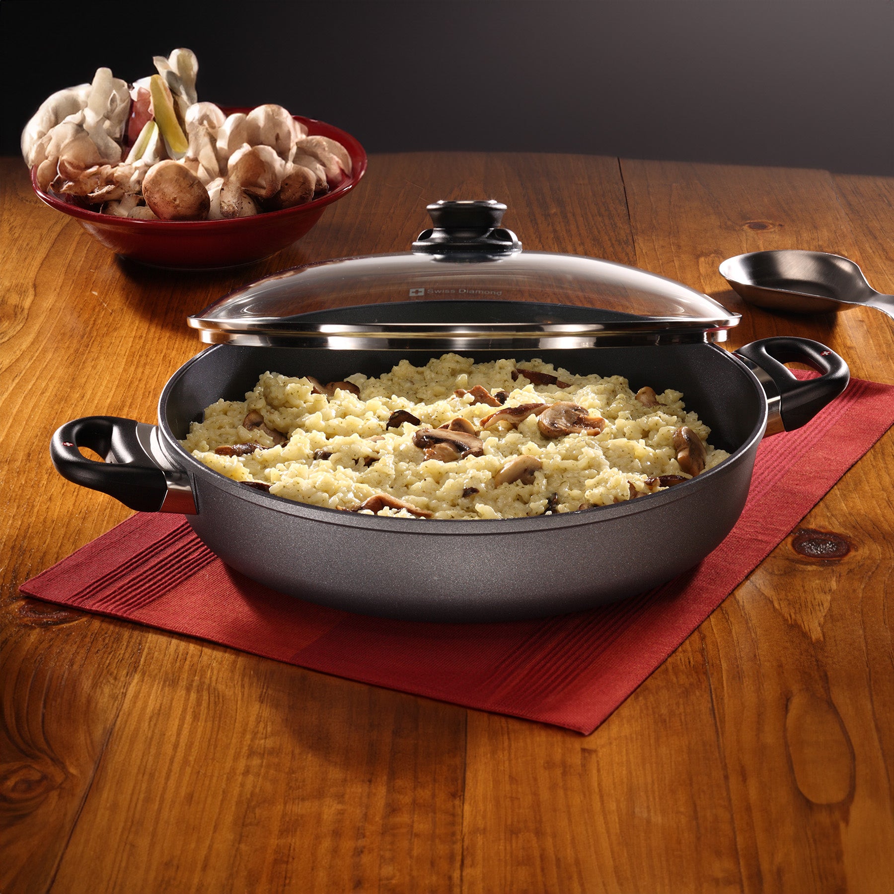 HD Nonstick Sauteuse with Glass Lid in use on wooden dining room table
