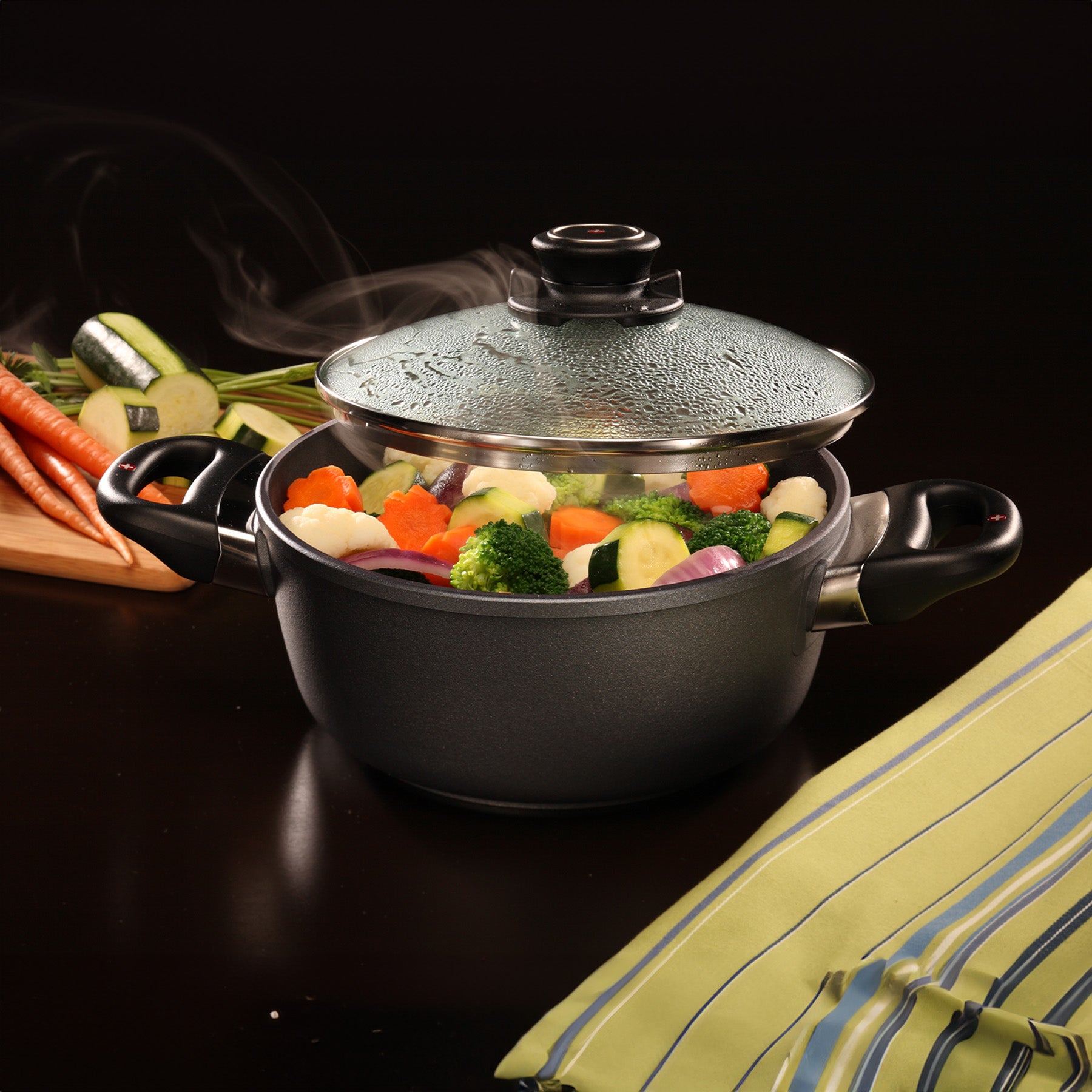 HD Nonstick Casserole with Glass Lid in use on black kitchen counter top
