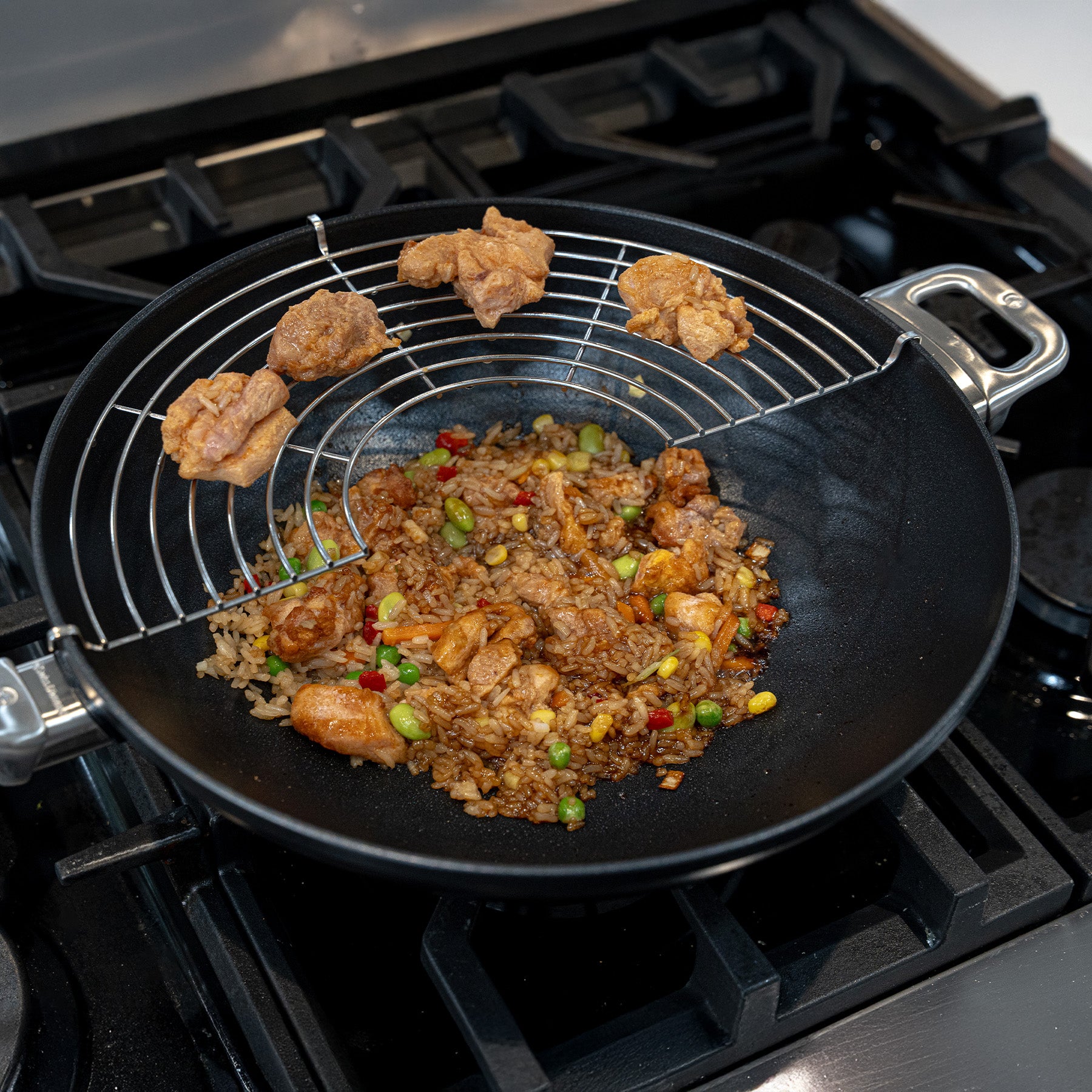 CHD Nonstick 12.5" Wok with tempura rack on gas stove with food inside