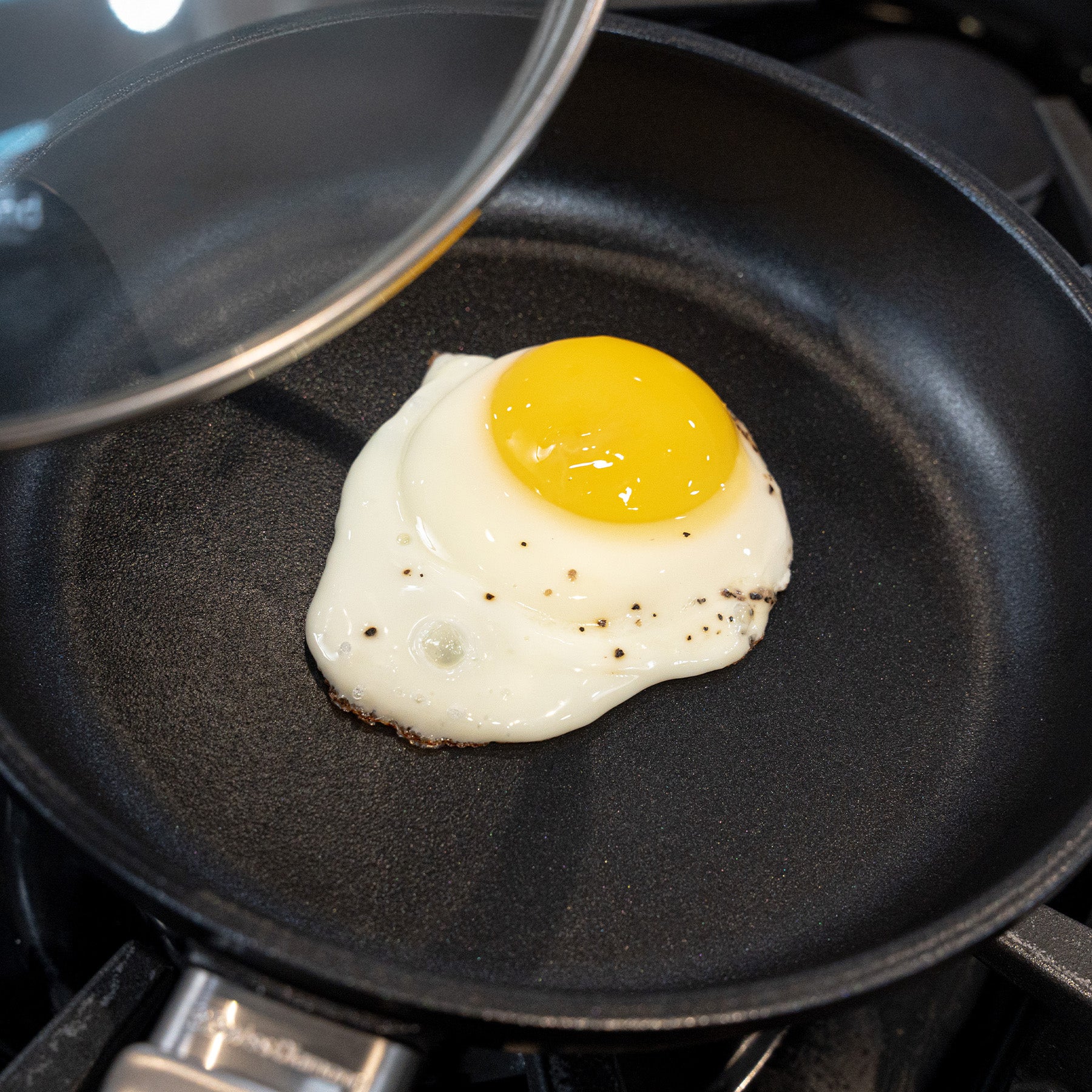 CHD Nonstick 8" Fry Pan with Glass Lid on gas stove top with food inside