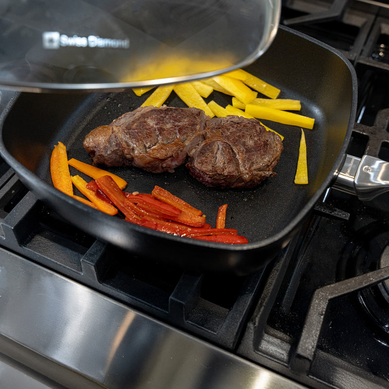 CHD Nonstick 11" x 11" Square Saute Pan with Glass Lid on gas stove with food inside