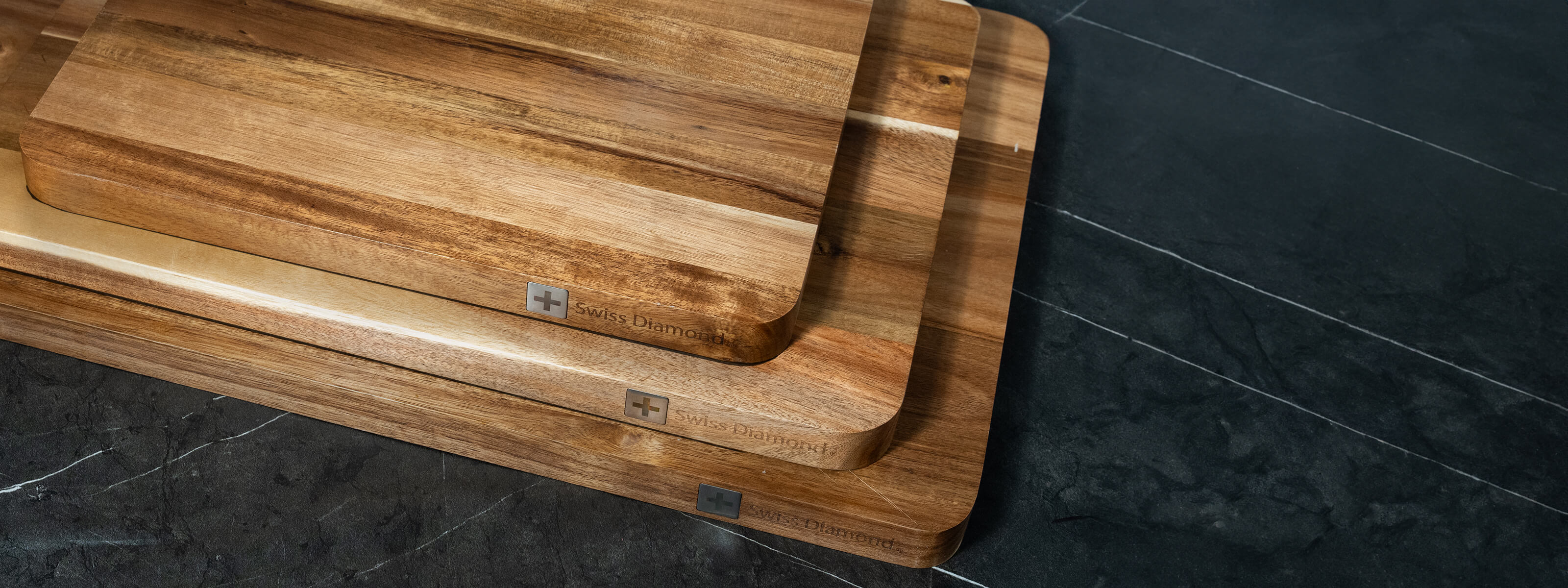 Acacia Wood Cutting Boards stacked on kitchen counter 