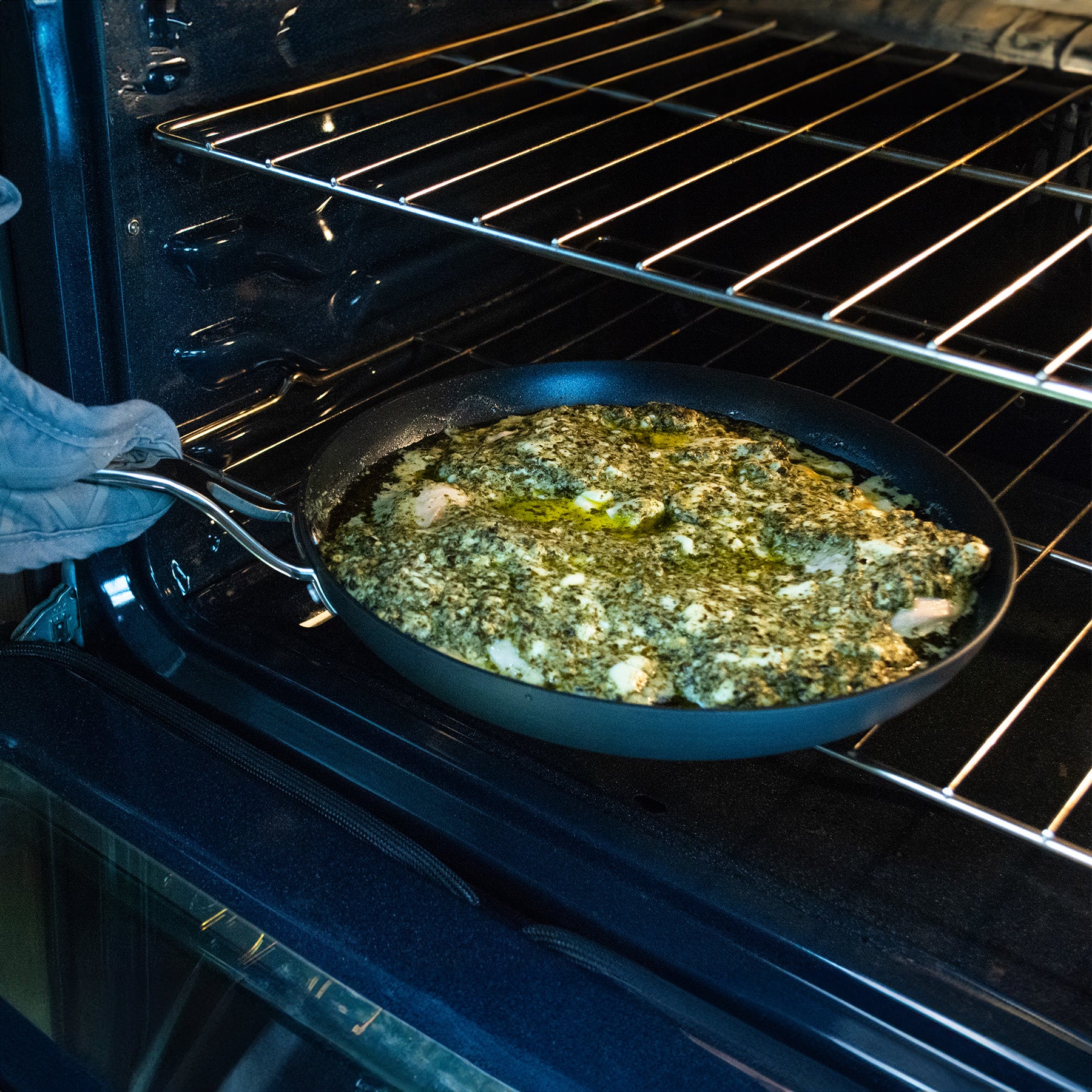 Hard Anodised Nonstick Fry Pan - Induction in use being put inside an oven on top of a rack