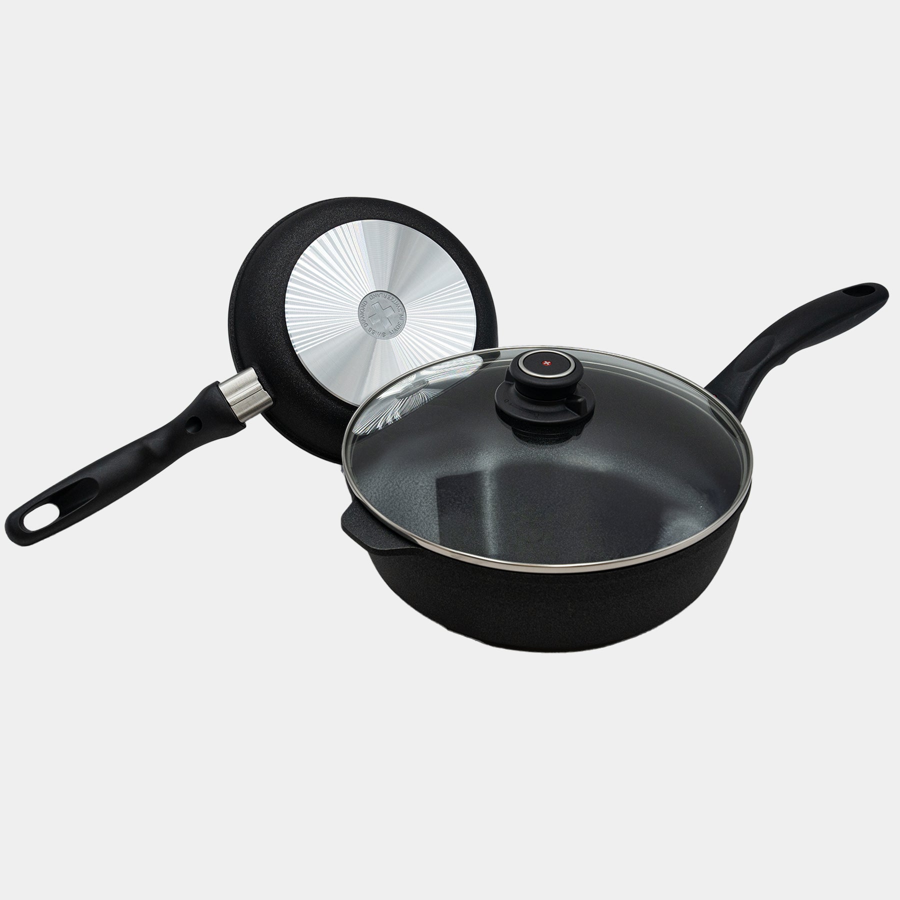 XD Nonstick 8" Fry Pan and 3.8 qt Saute Pan with Glass Lid Set angled with a flipped over pan showing bottom of pan