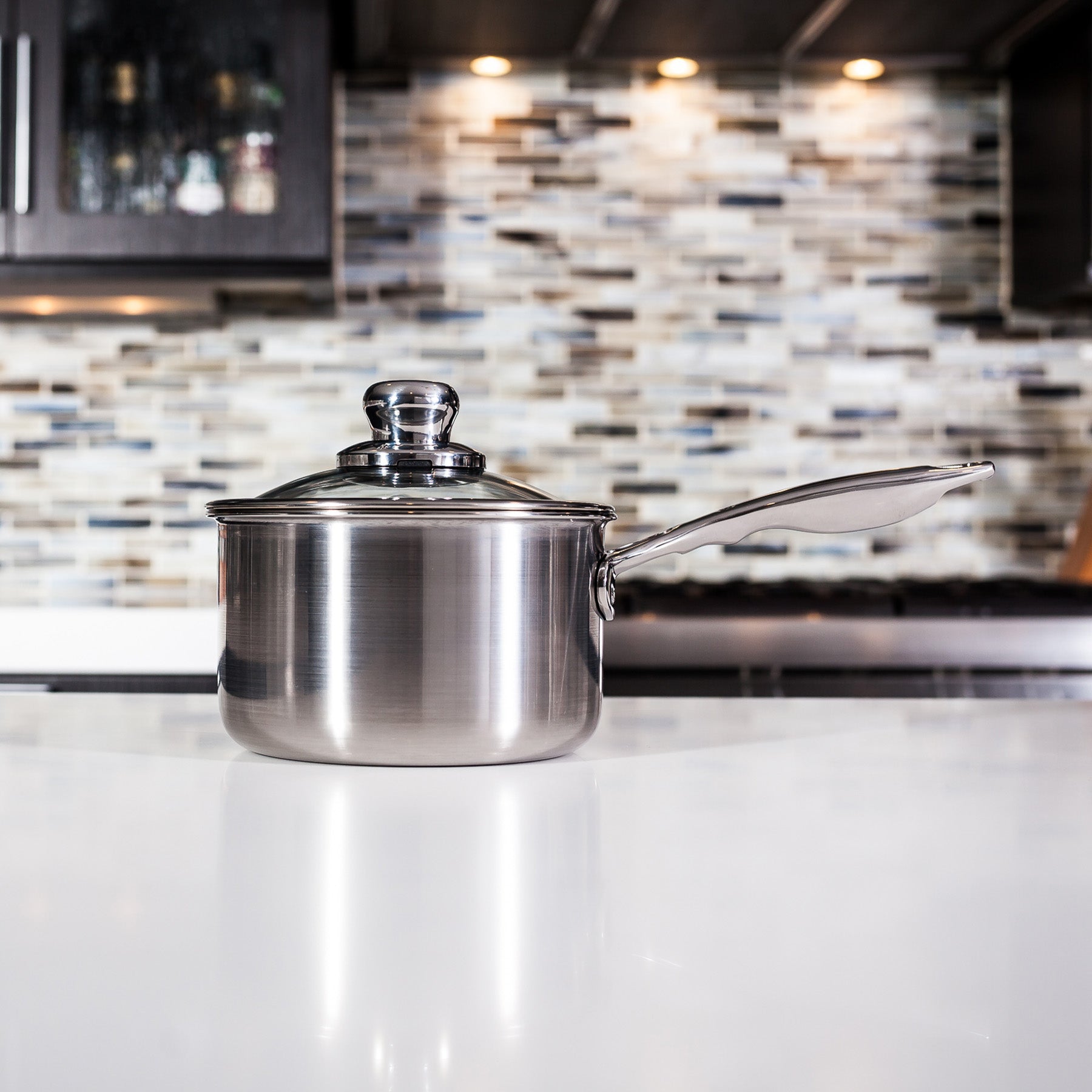 Premium Clad Saucepan with Glass Lid - Induction in use on kitchen counter
