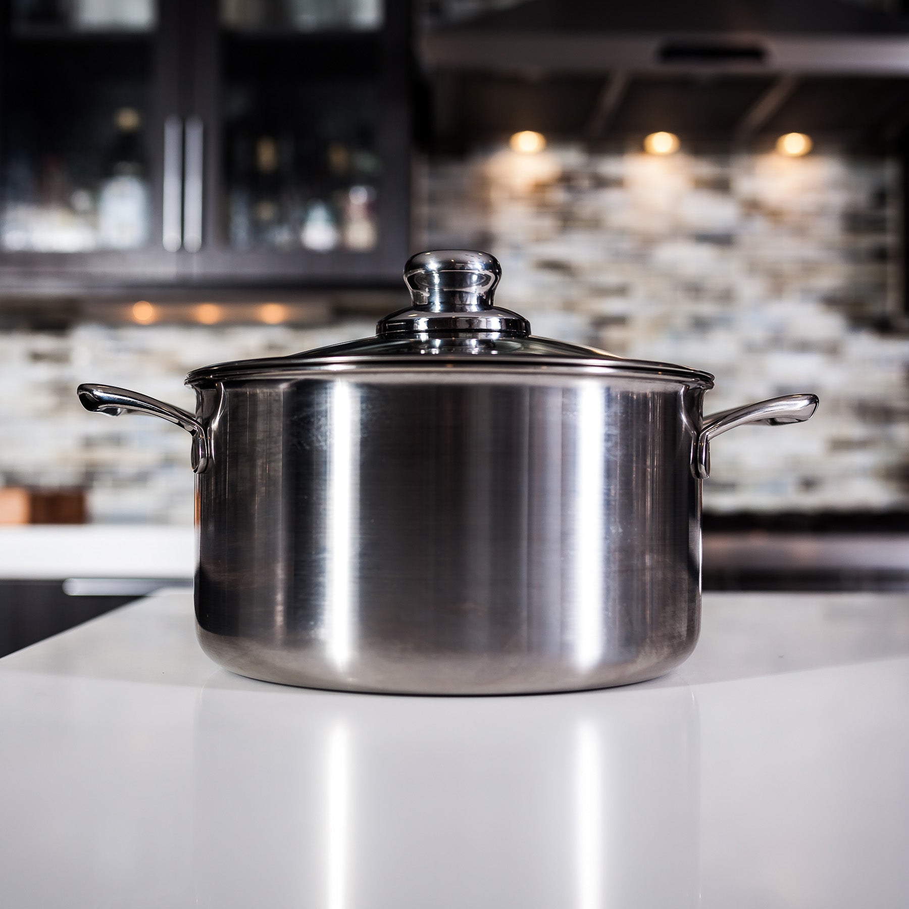 Premium Clad 6.3 qt Dutch Oven with Glass Lid - Induction in use on kitchen counter