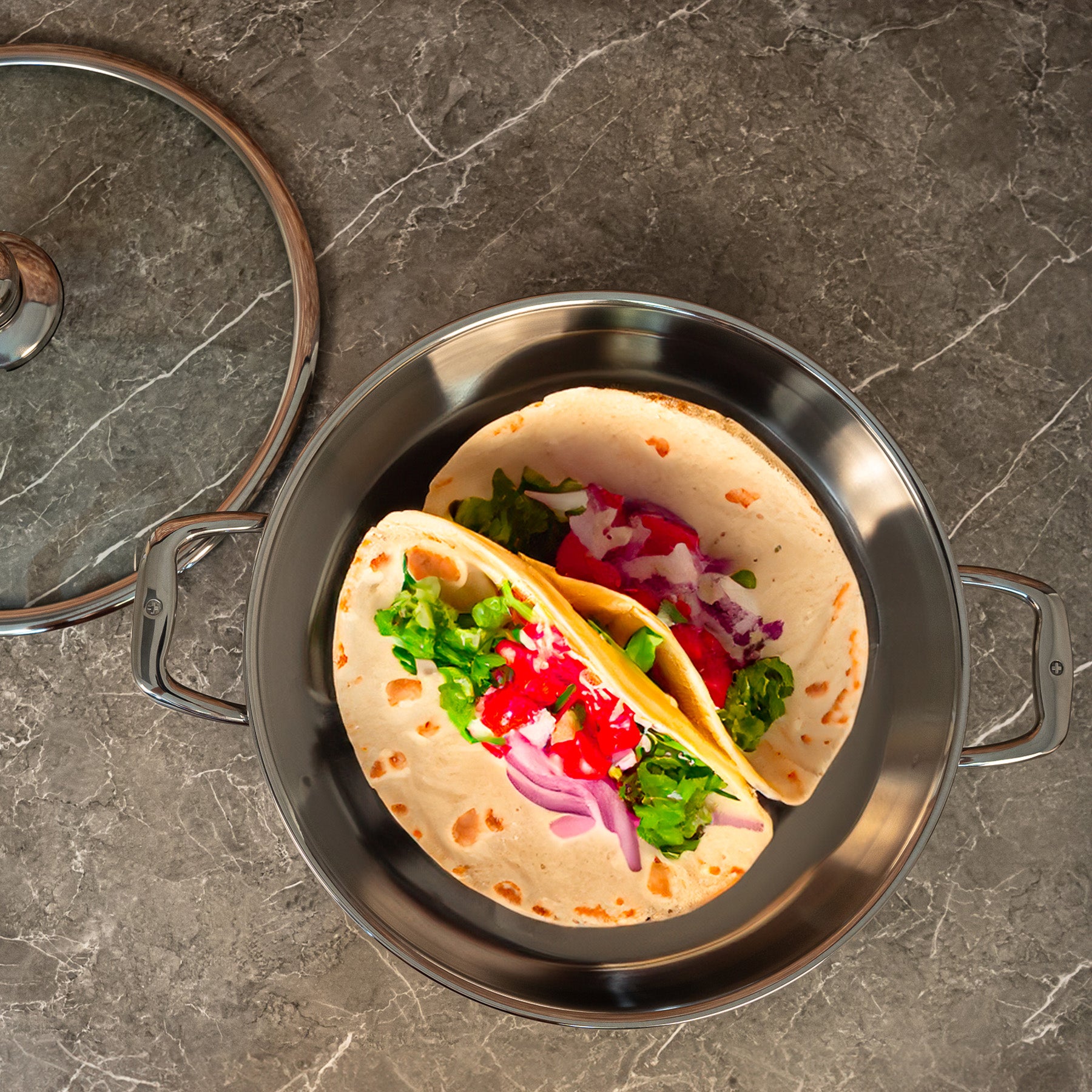 Premium Clad 5.3 qt Stainless Chef's Pan with Glass Lid - Induction in use with four tortillas dish on surface