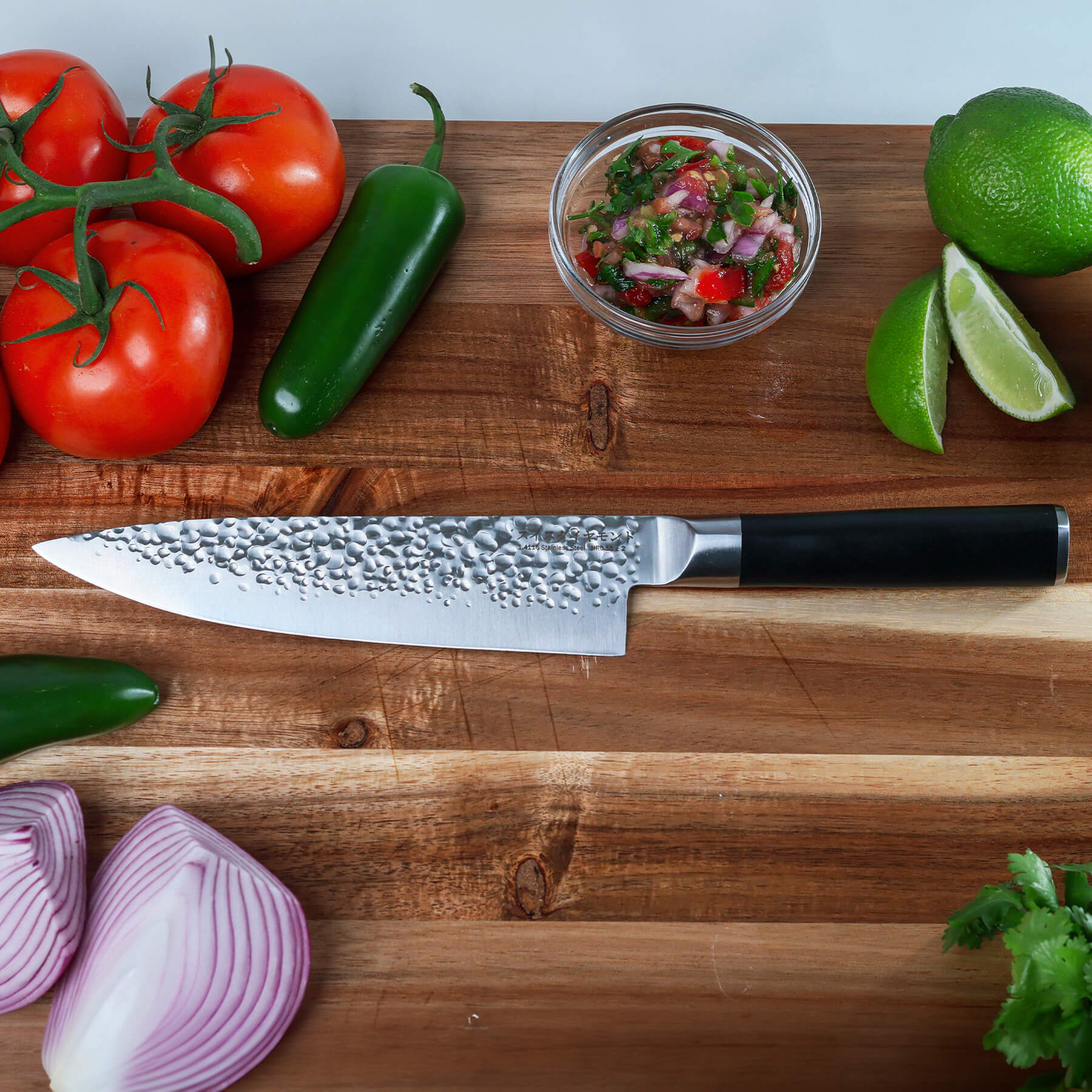 8" Hammered Chef Knife on cutting board with vegetables 
