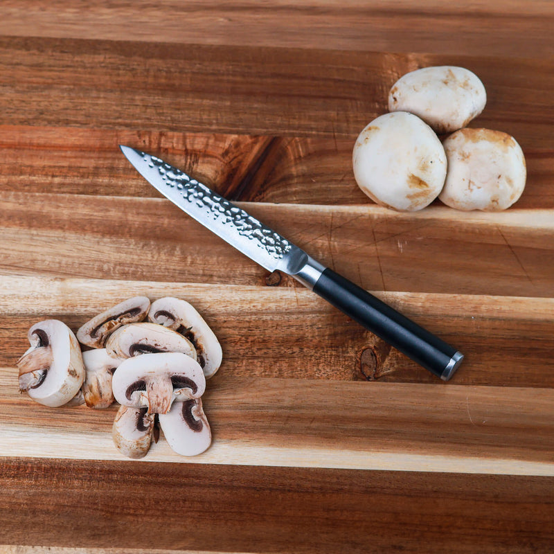 5" Hammered Utility Knife on wooden cutting board with sliced mushrooms