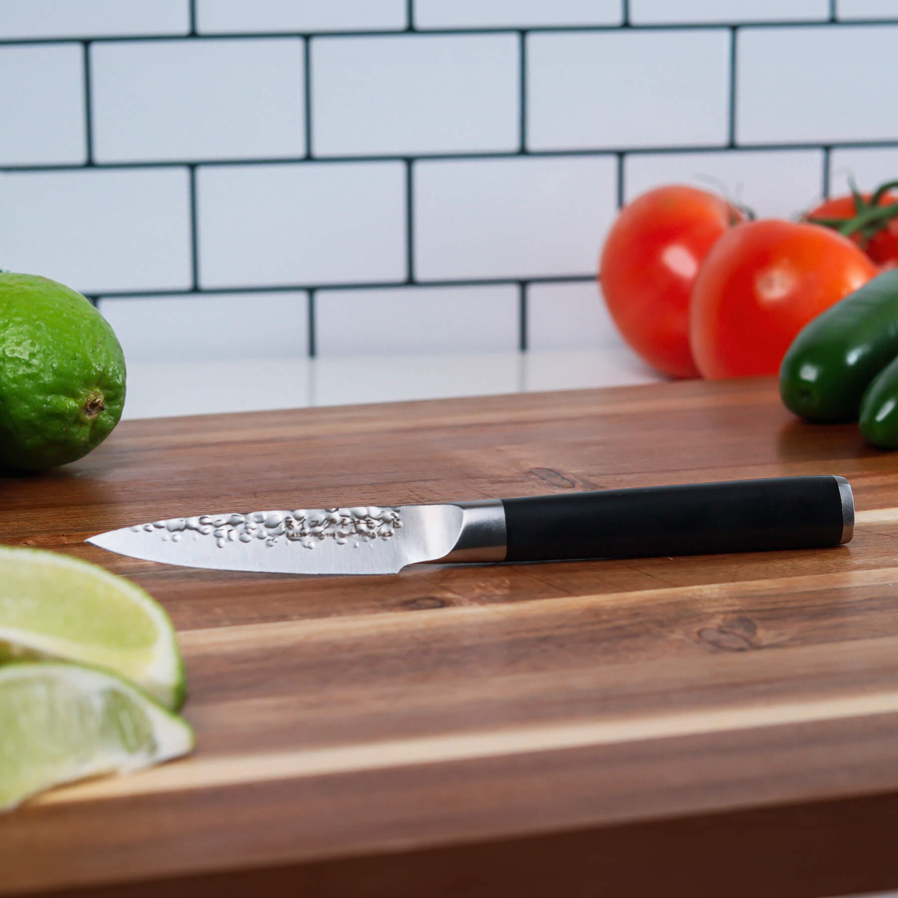 4" Hammered Paring Knife on cutting board with vegetables