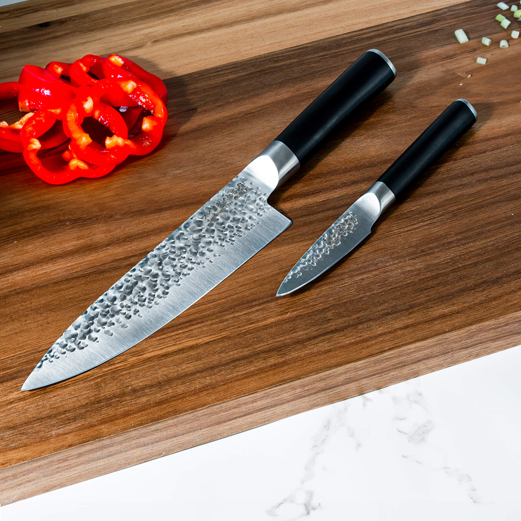 Hammered Chef Paring Set on wooden cutting board with food