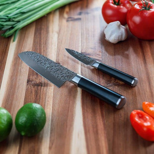 Hammered Santoku Paring Set on wooden cutting board with food