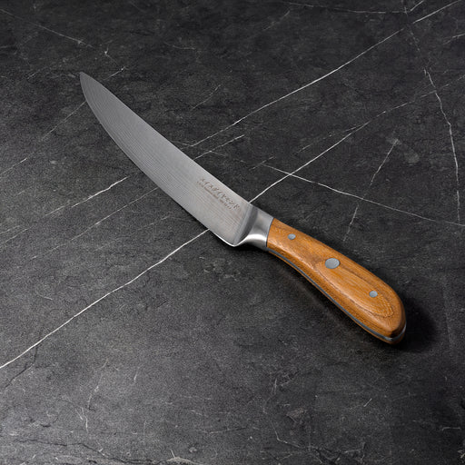 8" Damascus Carving Knife angled view on black kitchen counter