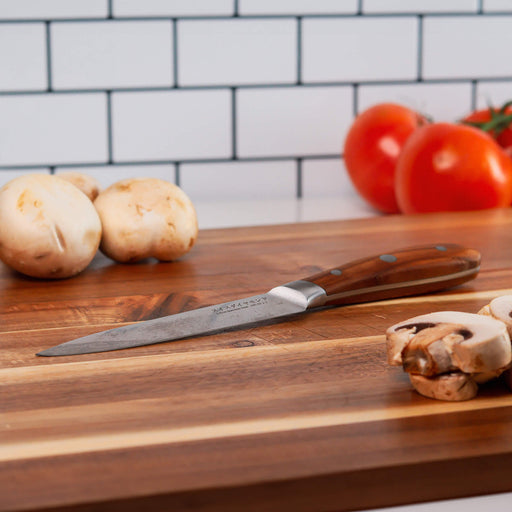 5" Damascus Utility Knife on cutting board with sliced mushrooms and other vegetables
