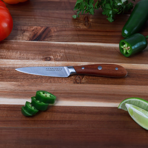 4" Damascus Paring Knife is on cutting board with sliced jalapenos