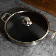 Nonstick Clad 5.3 qt Stainless Chef's Pan with Glass Lid - Induction in use with lid on top and view from above on kitchen counter