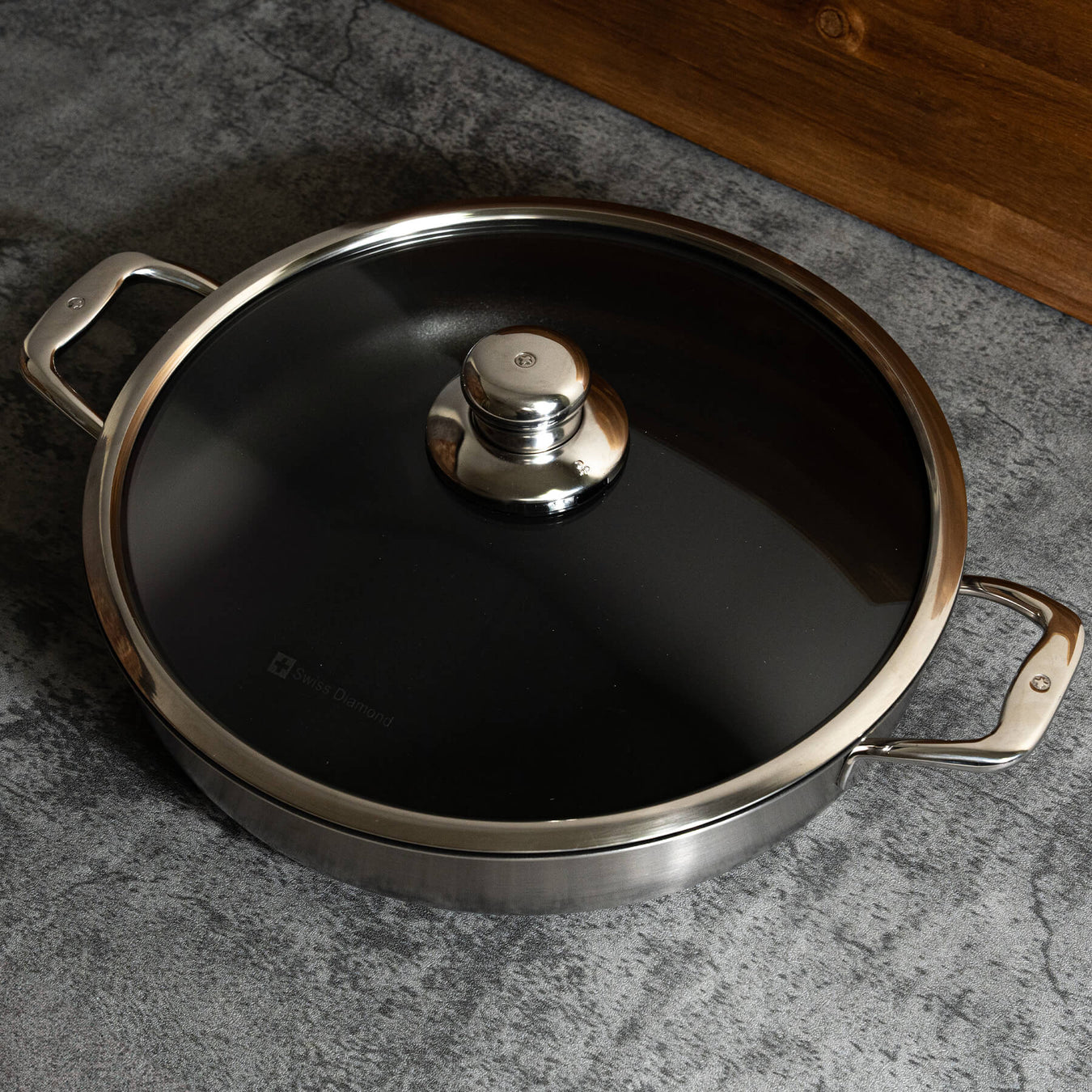 Nonstick Clad 5.3 qt Stainless Chef's Pan with Glass Lid - Induction in use with lid on top and view from above on kitchen counter
