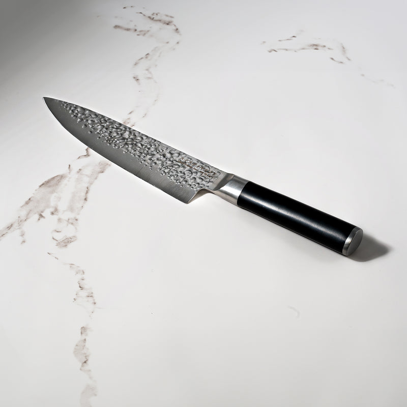 8" Hammered Chef Knife on white marble kitchen counter top