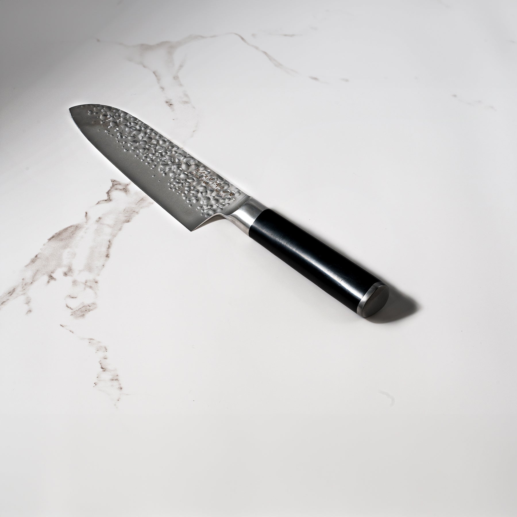 7" Hammered Santoku Knife on Kitchen white marble counter top