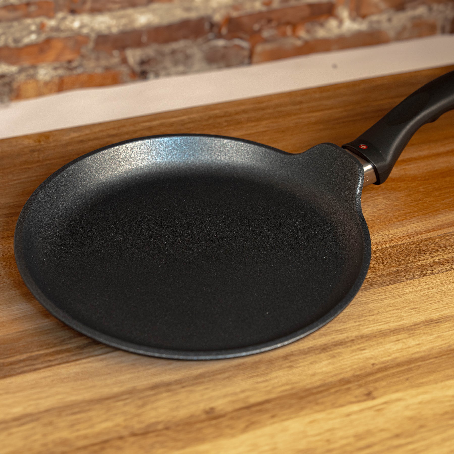 XD Nonstick Crepe Pan angled view on wooden table