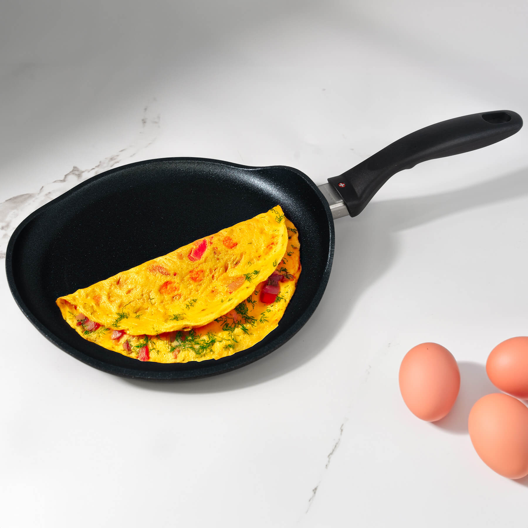 XD Nonstick Crepe Pan - Induction in use with food on surface on a kitchen counter top