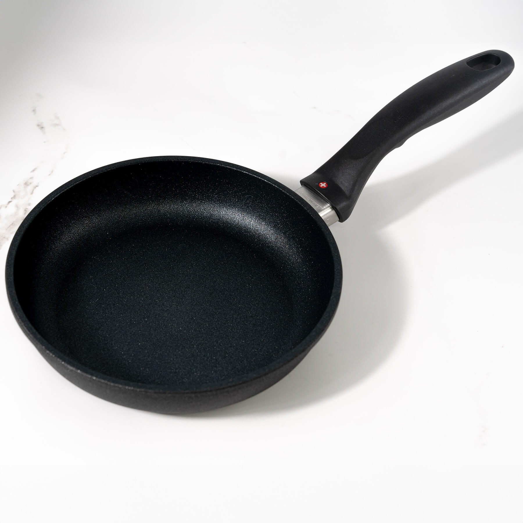 XD Nonstick Fry Pan angle view on marble kitchen counter