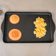 XD Nonstick 17" x 11" Double-Burner Griddle in use with pancakes and eggs on surface
