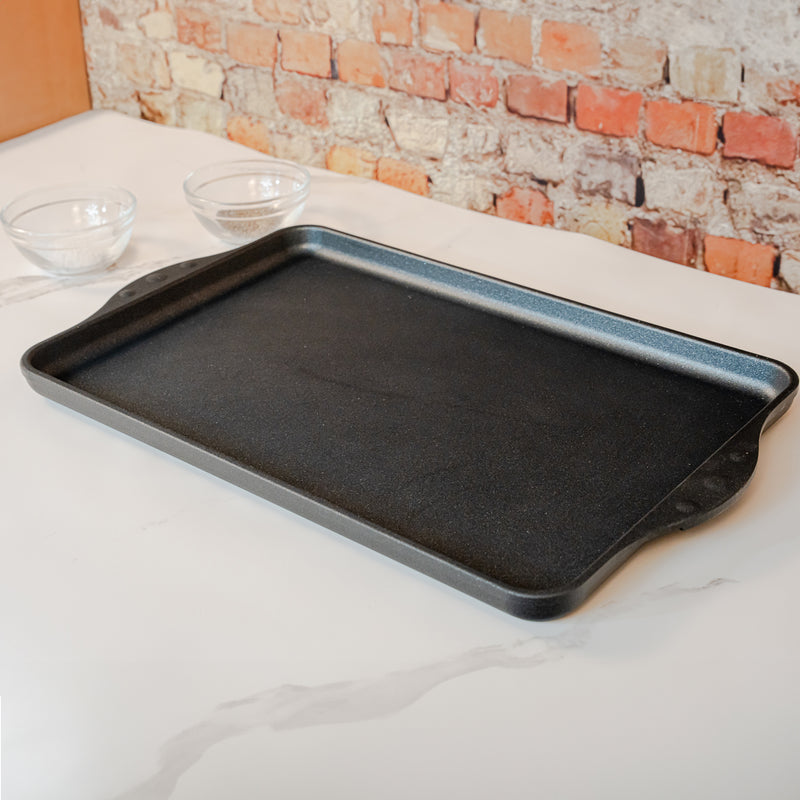 XD Nonstick 17" x 11" Double-Burner Griddle in use on white counter top