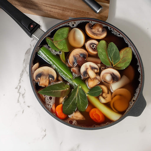 XD Nonstick 3.2 qt Saute Pan with Detachable Handle - Induction in use with food in side on kitchen counter