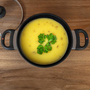 XD Nonstick Casserole with Glass Lid with food inside top view placed on a wooden table