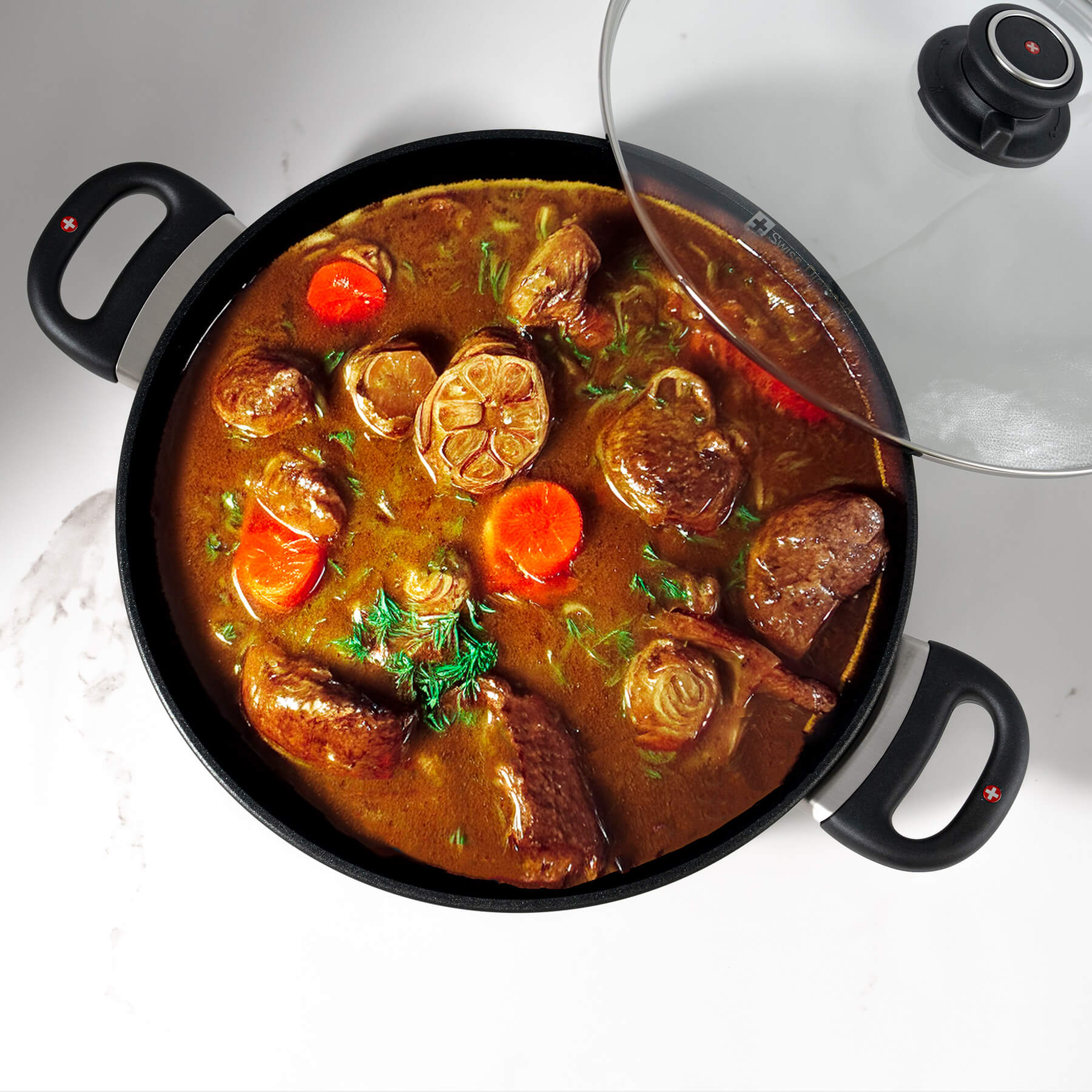 XD Nonstick Braiser with Glass Lid - Induction in use with food inside pot on kitchen counter