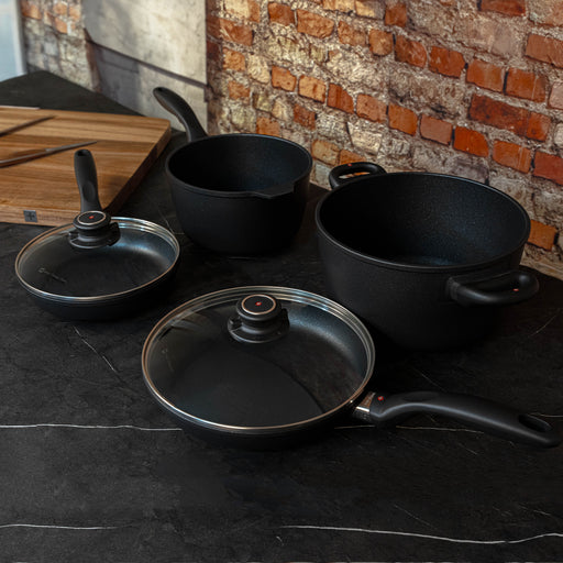XD Nonstick 6-Piece Set - Fry Pan, Saucepan & Soup Pot - Induction top angled view on black marble counter top