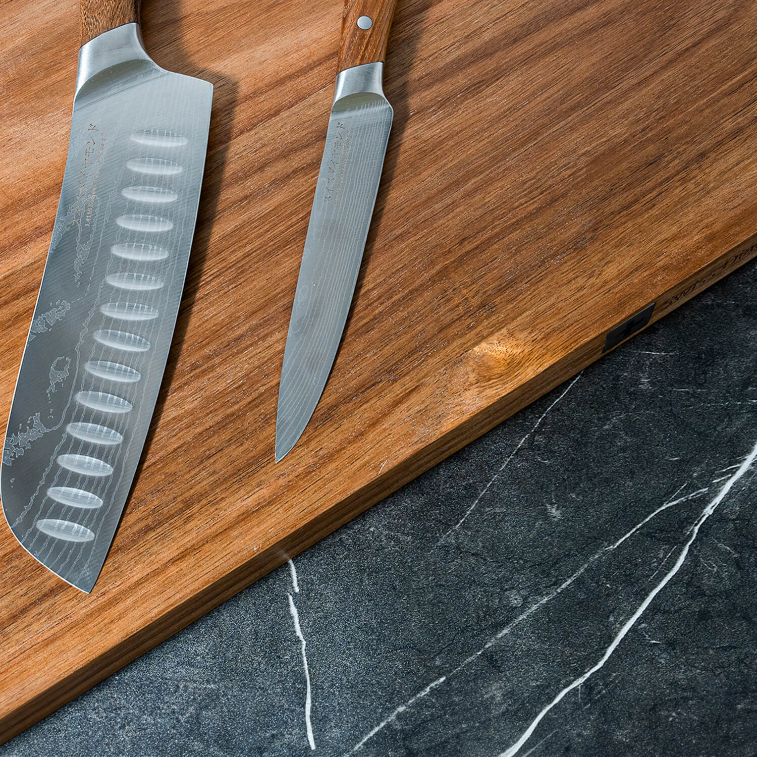 cutting boards at angle top view with two knives laying on top